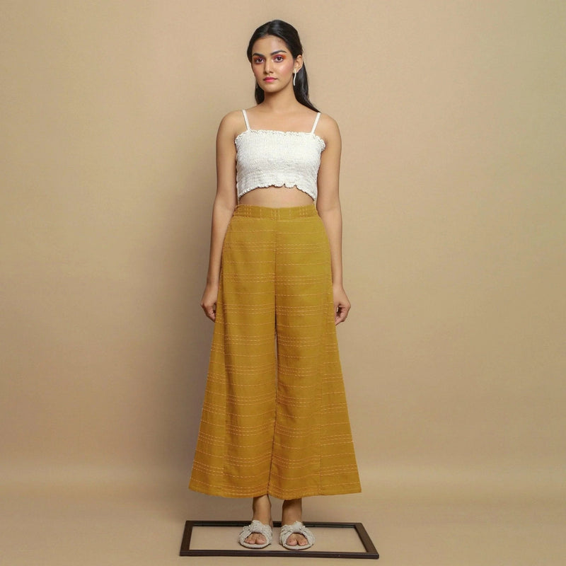 Front View of a Model wearing Mustard Paneled Striped Handwoven Pant