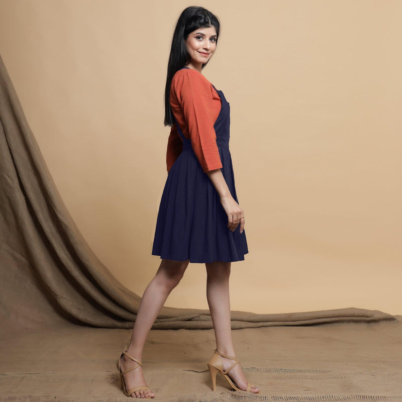 Left View of a Model wearing Navy Blue Cotton Flax Knee Length Criss-Cross Back Dress