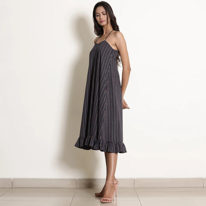 Left View of a Model wearing Navy Blue Striped Halter Neck Frilled Dress