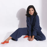 Front View of a Model wearing Navy Blue Cotton Waffle Turtle Neck Overalls