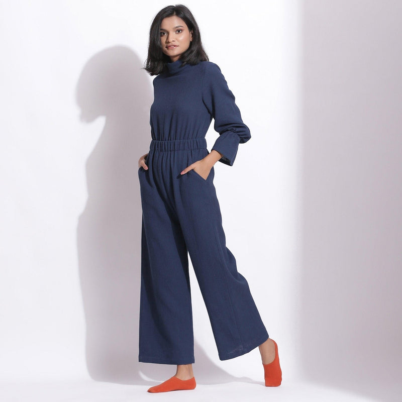 Left View of a Model wearing Navy Blue Cotton Waffle Turtle Neck Overalls