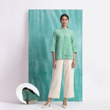 Front View of a Model wearing Ocean Green Handspun Cotton Mandarin Collar Button-Down Top