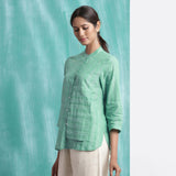 Left View of a Model wearing Ocean Green Handspun Cotton Mandarin Collar Button-Down Top