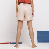 Back View of a Model wearing Off-White and Pink Checks Yarn-Dyed Cotton Paneled Shorts