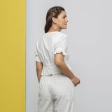 Back View of a Model wearing Off-White Cotton Schiffli Floral Top