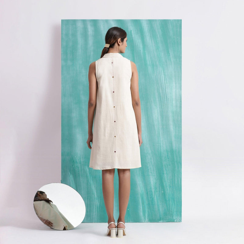 Back View of a Model wearing Off-White Handspun Cotton Muslin Button-Down Short Dress