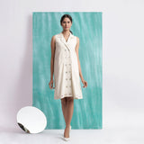 Front View of a Model wearing Off-White Handspun Cotton Muslin Button-Down Short Dress