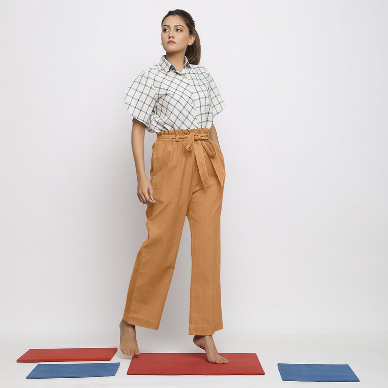 Front View of a Model wearing Rust Vegetable Dyed Wide Legged Paperbag Pant