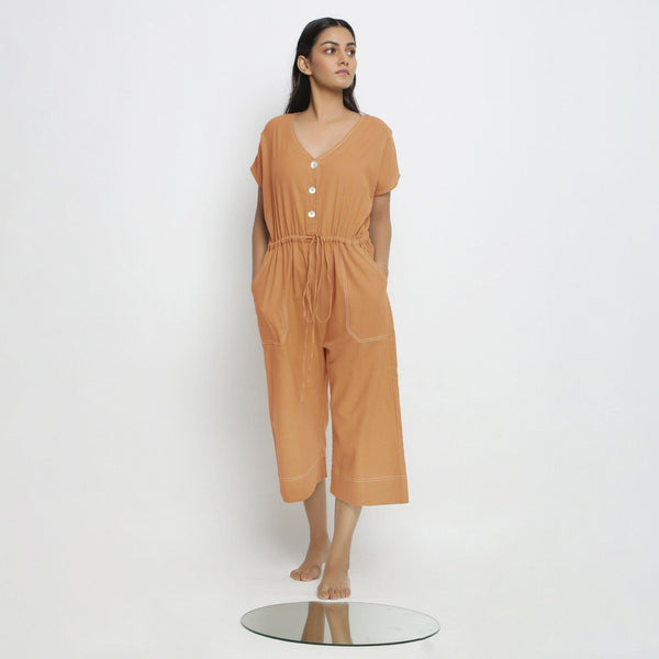 Front View of a Model wearing Rust Vegetable Dyed Button-Down Jumpsuit