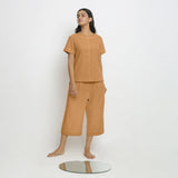 Front View of a Model wearing Orange Paneled Top and Mid-Rise Culottes Set