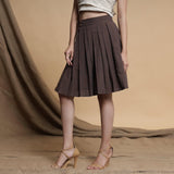 Left View of a Model wearing Orange and Brown Reversible Pleated Flared Skirt