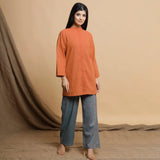 Right View of a Model wearing Orange Cotton High Neck Double Placket Coat