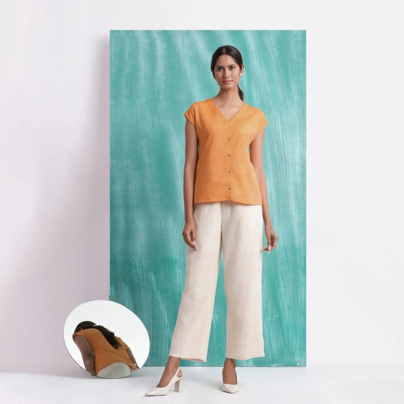 Front View of a Model wearing Orange Hand Mirror Work Drop Shoulder Top