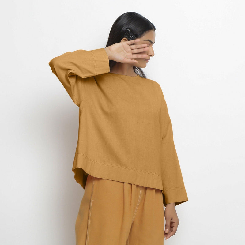 Right View of a Model wearing Vegetable-Dyed Orange 100% Cotton Straight Top