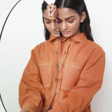 Front Detail of a Model wearing Rust Vegetable Dyed Handspun Cotton Button-Down Jacket