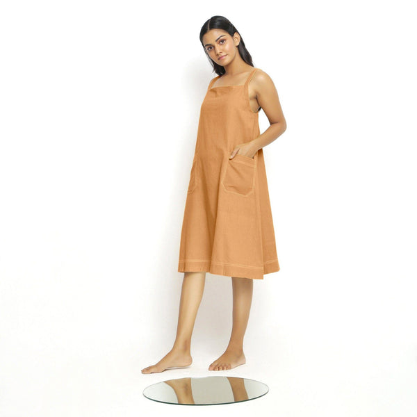 Left View of a Model wearing Rust Vegetable Dyed Handspun Slip Dress