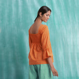 Back View of a Model wearing Orange Handspun Mirror Work Yoked Top