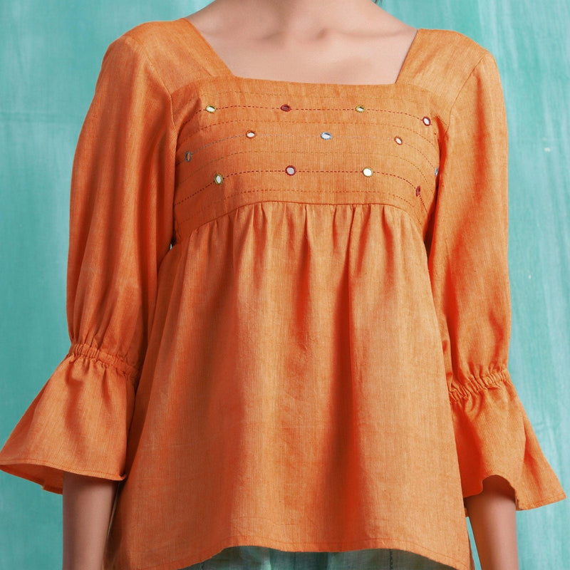 Front Detail of a Model wearing Orange Handspun Mirror Work Yoked Top