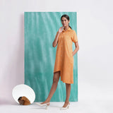 Left View of a Model wearing Orange Mirrored Asymmetrical Shirt Dress