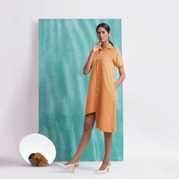 Left View of a Model wearing Orange Mirrored Asymmetrical Shirt Dress