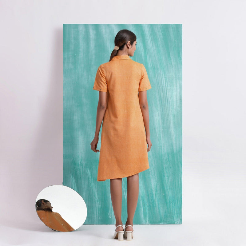 Back View of a Model wearing Orange Mirrored Asymmetrical Shirt Dress