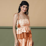 Right View of a Model wearing Orange Shibori Tier Camisole Top