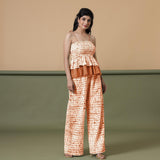 Front View of a Model wearing Orange Shibori Top and Wide-Legged Pant Set