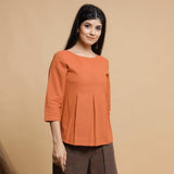 Front View of a Model wearing Orange Box-Pleated High Low Top