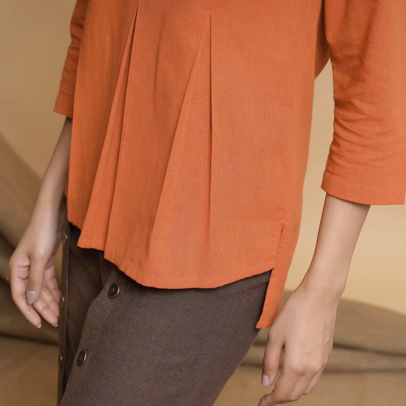 Left Detail of a Model wearing Orange Yarn Dyed Cotton Pleated High-Low Top