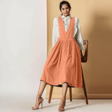 Front View of a Model wearing Peach Cotton Flax Pinafore Midi Wrap Dress