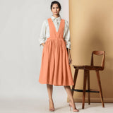 Front View of a Model wearing Peach Cotton Flax Pinafore Midi Wrap Dress