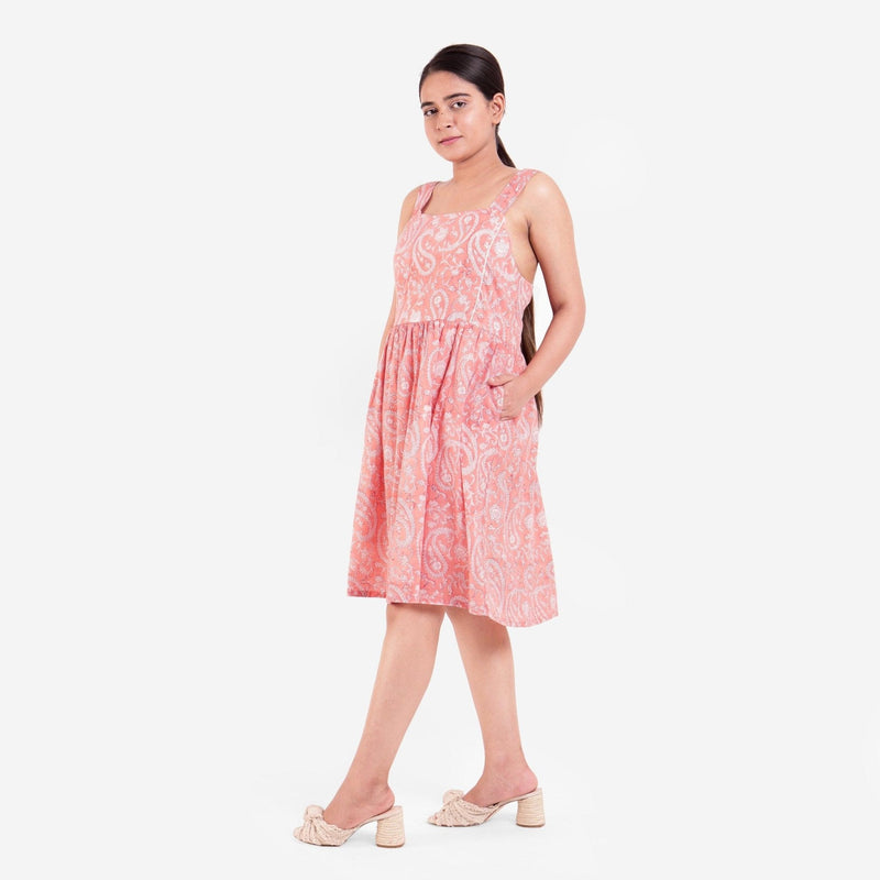 Left View of a Model wearing Peach Paisley Block Print Cotton Knee Length Dress