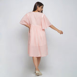 Back View of a Model wearing Peach Lined Cotton Chambray Dress