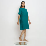 Right View of a Model wearing Pine Green 100% Linen Knee Length Yoked Dress