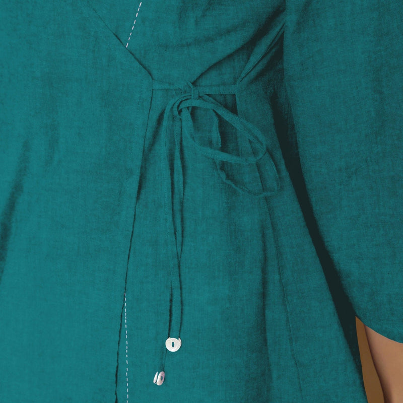 Front Detail of a Model wearing Pine Green Linen Asymmetrical V-Neck Top