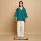 Front View of a Model wearing Pine Green Linen Asymmetrical V-Neck Top