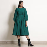 Front View of a Model wearing Warm Pine Green Frilled Yoke Dress