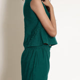 Right Detail of a Model wearing Warm Pine Green V-Neck Flared Top