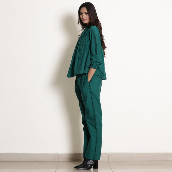 Left View of a Model wearing Warm Pine Green Frilled Top and Pant Set