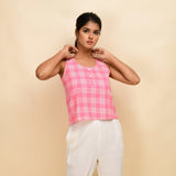 Front View of a Model wearing Pink Checks Cotton Muslin Sleeveless Round Neck Top