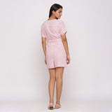 Back View of a Model wearing Pink Button-Down Short V-Neck Romper