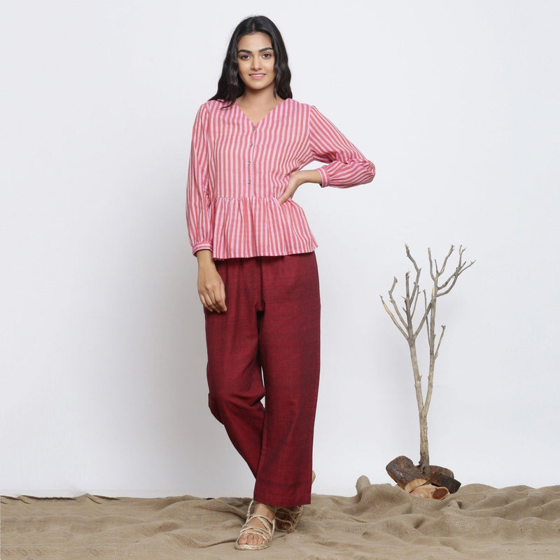 Front View of a Model wearing Pink Handspun Button-Down Peplum Top