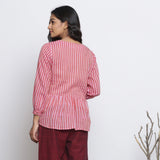 Back View of a Model wearing Pink Handspun High Low Button-Down Top