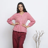 Front View of a Model wearing Pink Handspun Button-Down Peplum Top