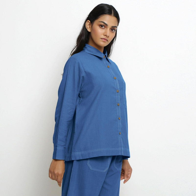 Right View of a Model wearing Vegetable Dyed Blue Button-Down Cotton Top