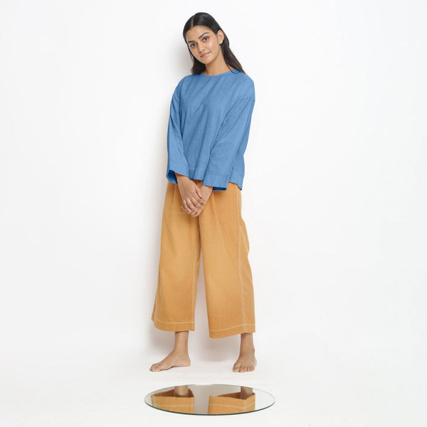 Front View of a Model wearing Vegetable-Dyed Blue 100% Cotton Straight Top