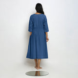 Back View of a Model wearing Vegetable-Dyed Blue 100% Cotton Button-Down Dress