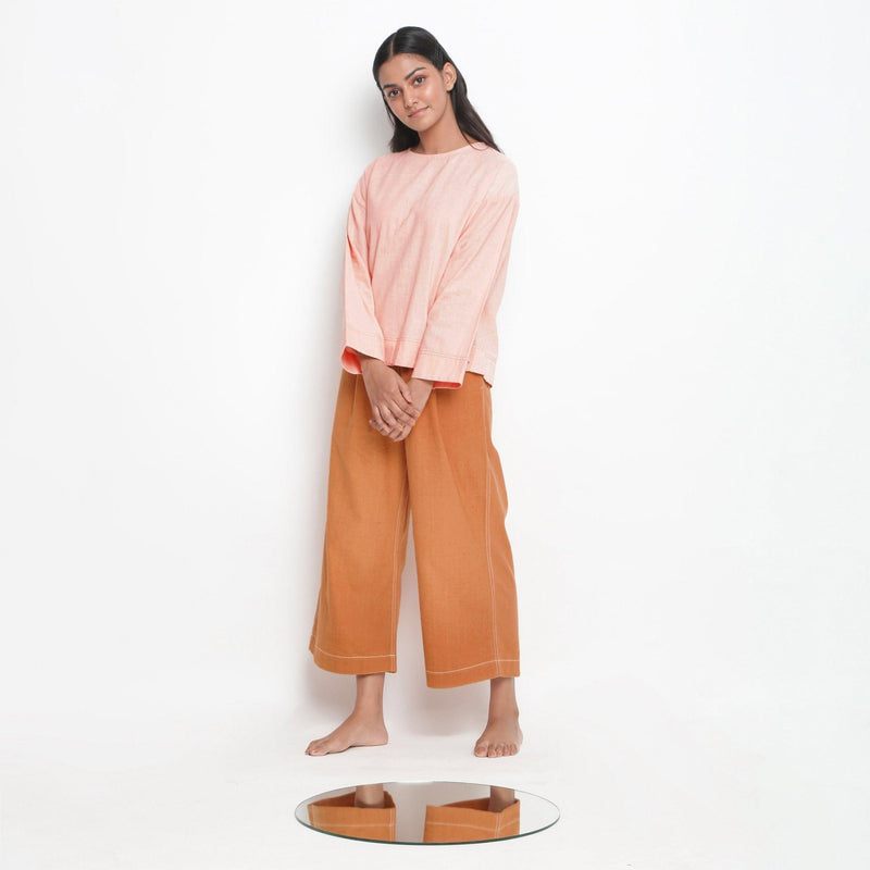 Front View of a Model wearing Powder Pink Vegetable Dyed Straight Fit Top