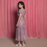 Left View of a Model wearing Powder Pink Chanderi Block Print Tier Peasant Dress