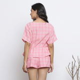 Back View of a Model wearing Pink Handspun Straight Top and Micro Shorts Set